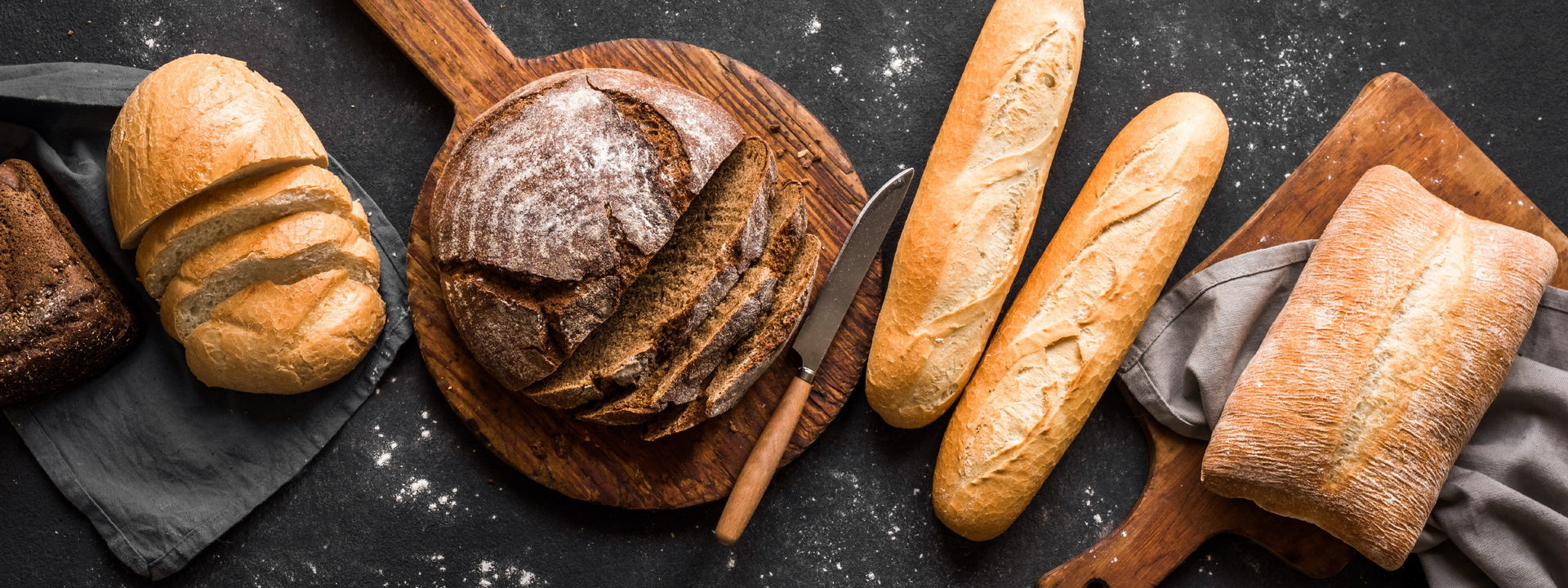 Fresh,Bread,On,Black,Background,,Top,View,,Copy,Space.,Homemade