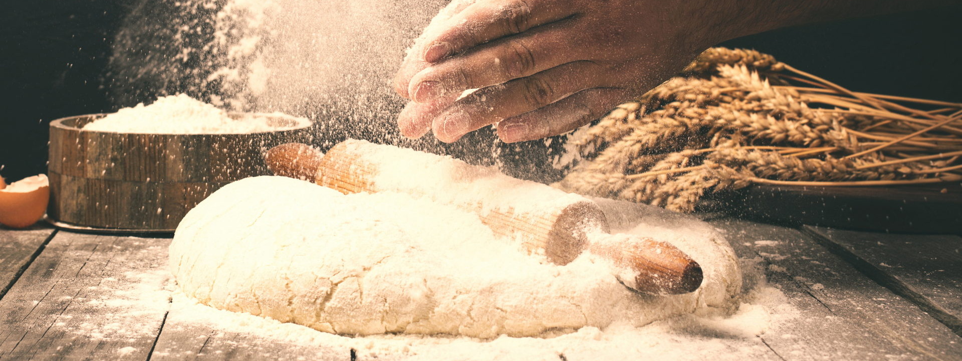 Man,Preparing,Bread,Dough,On,Wooden,Table,In,A,Bakery